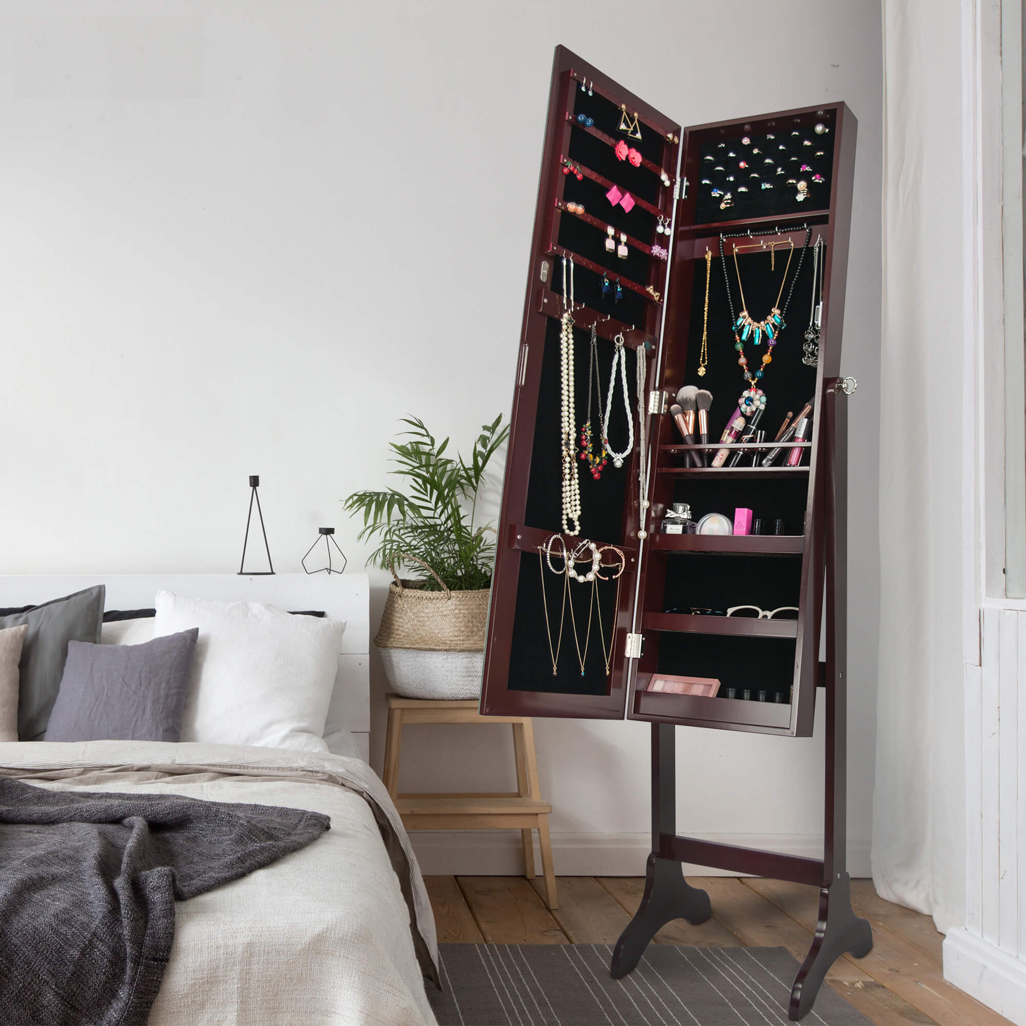 A scene displaying the brown jewelry cabinet standing mirror with its doors open, showcasing its interior organization and storage capabilities.